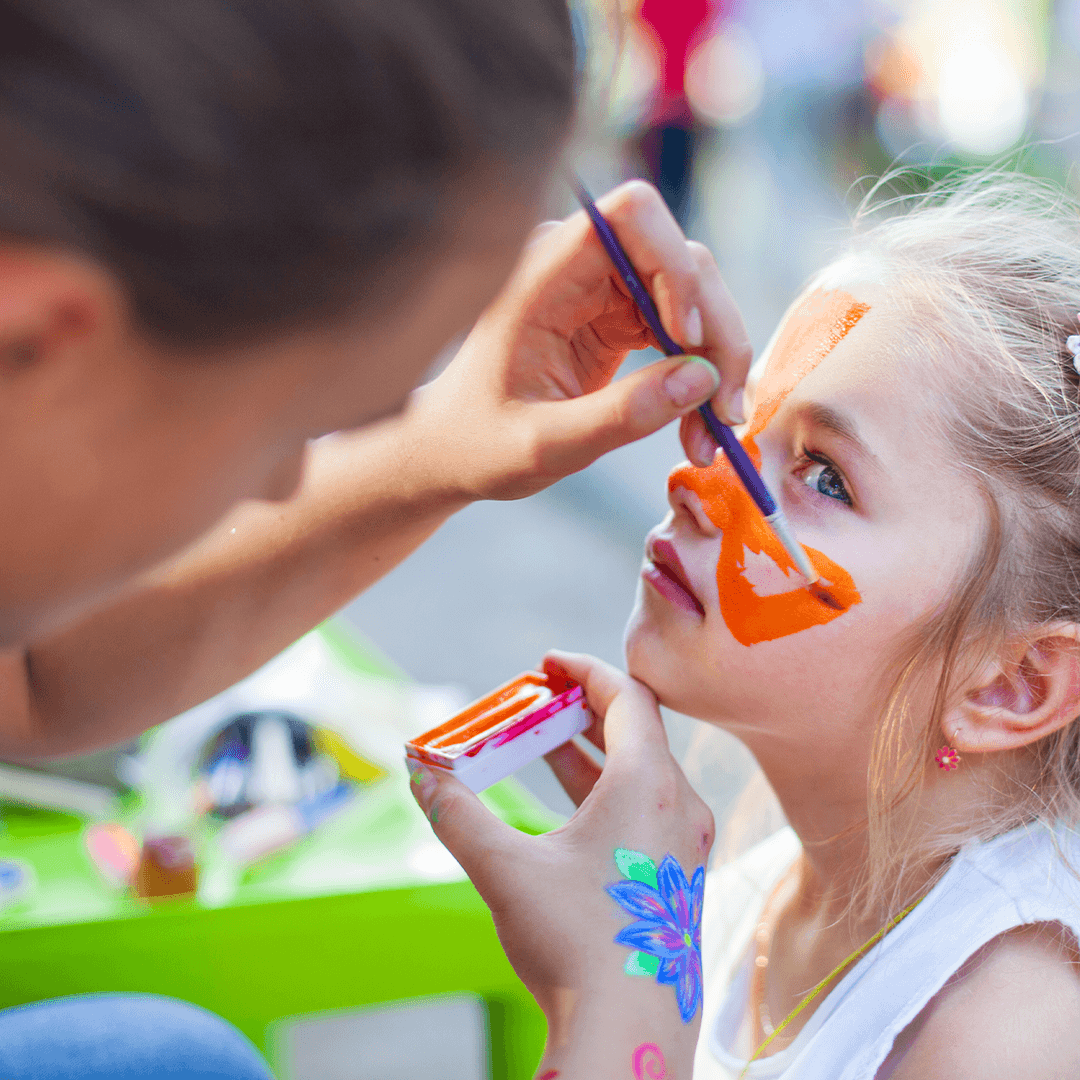 Mom painting her daughter’s face – creative and cozy summer activity for kids
