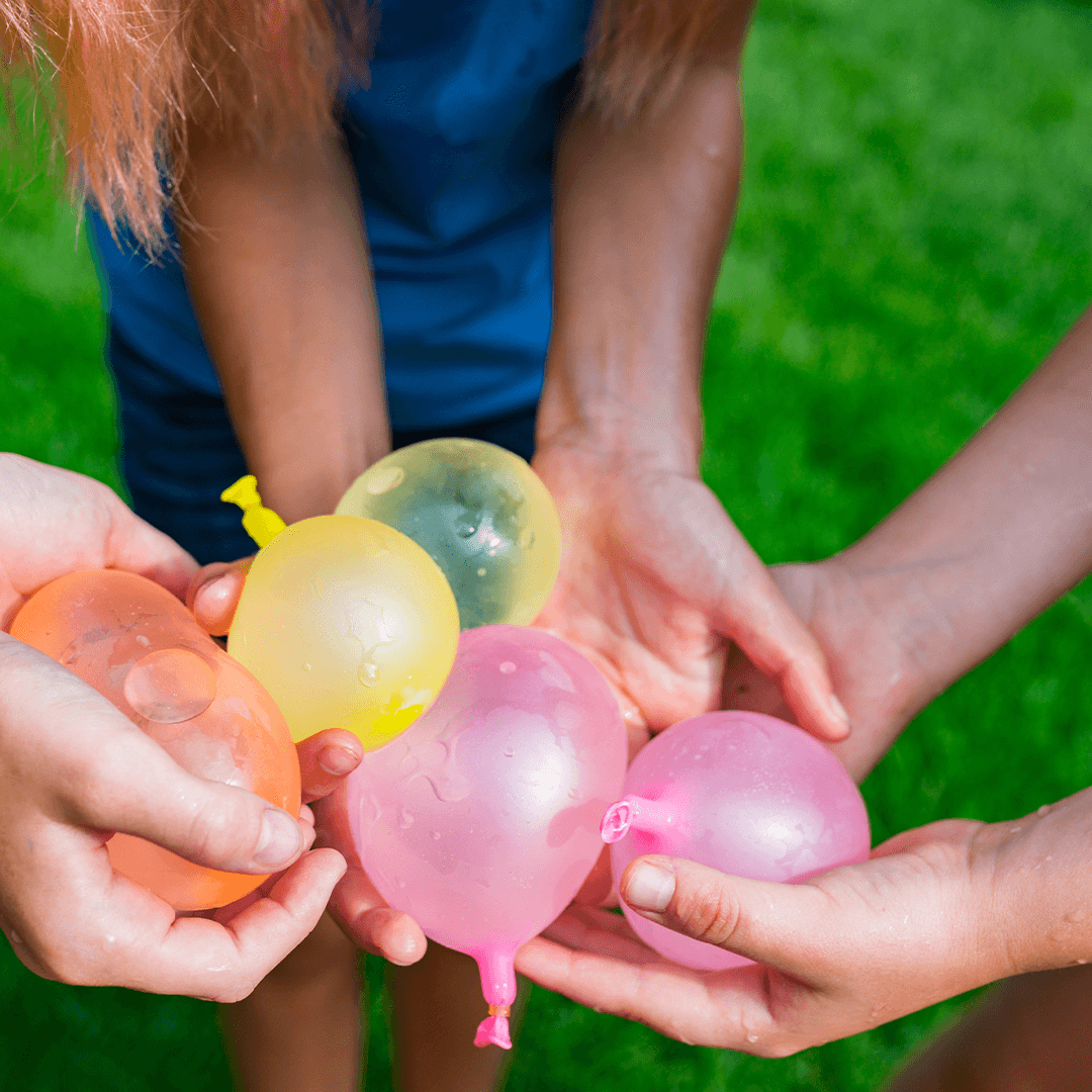 Kids playing with water balloons – energetic and fun summer activity for children